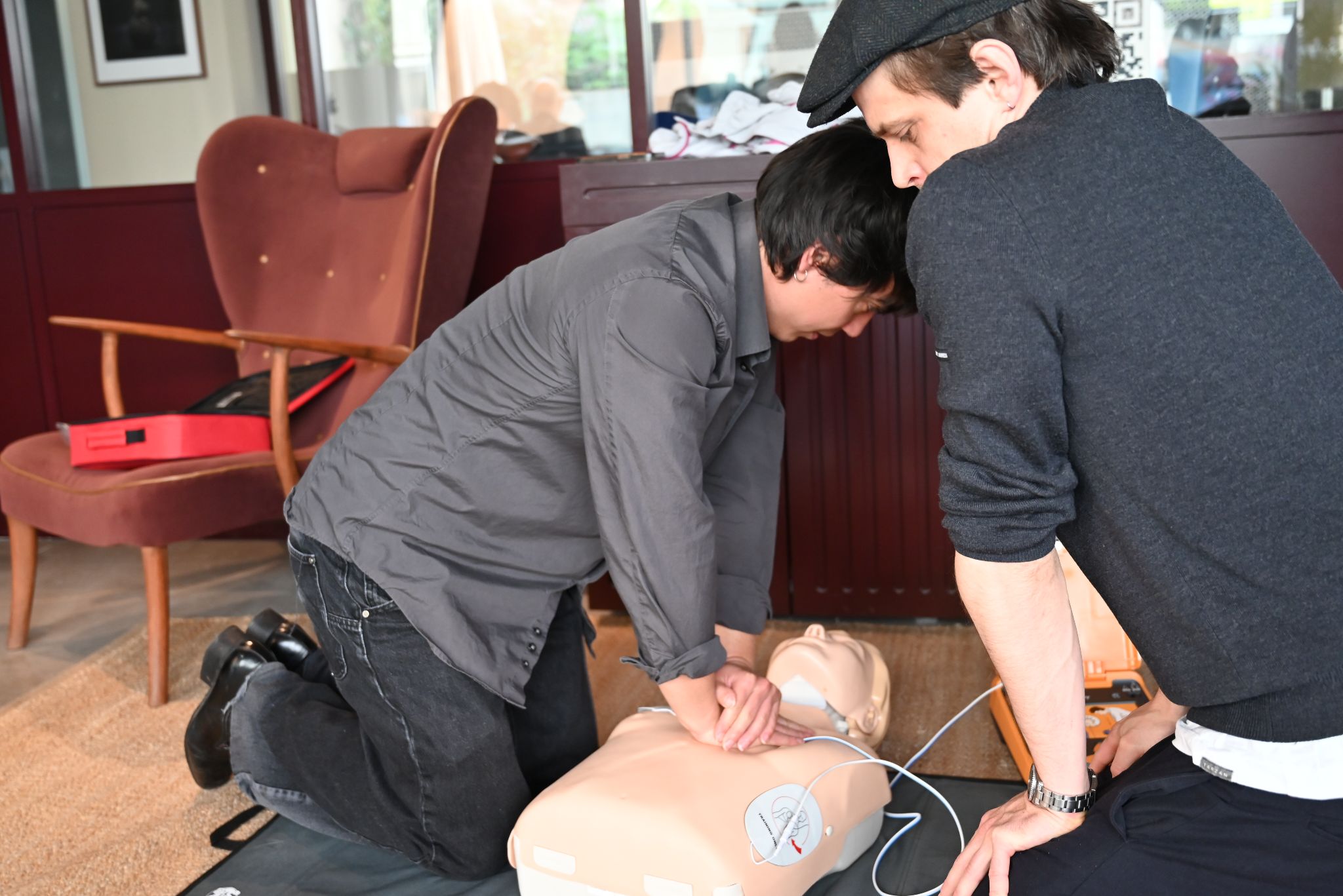 Erste-Hilfe-Training mit AED Defibrillator – Herzdruckmassage an einer Reanimationspuppe